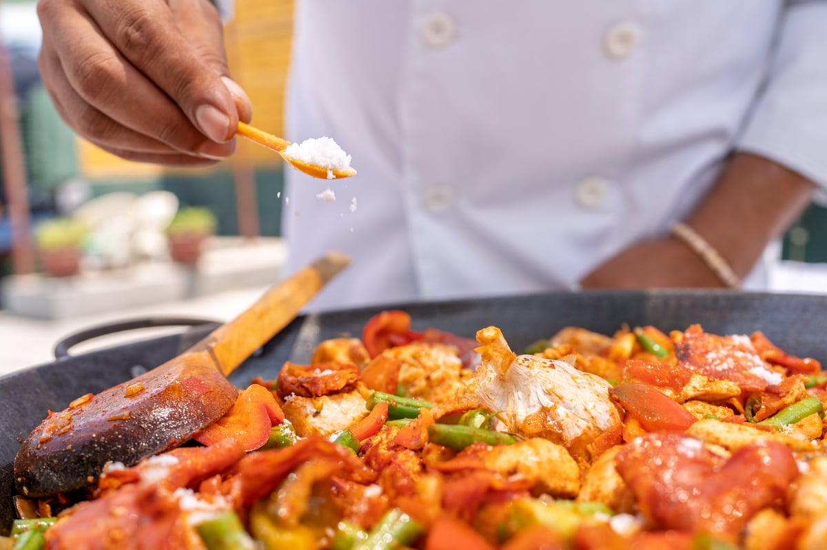 Private chef preparing gourmet meal in villa kitchen