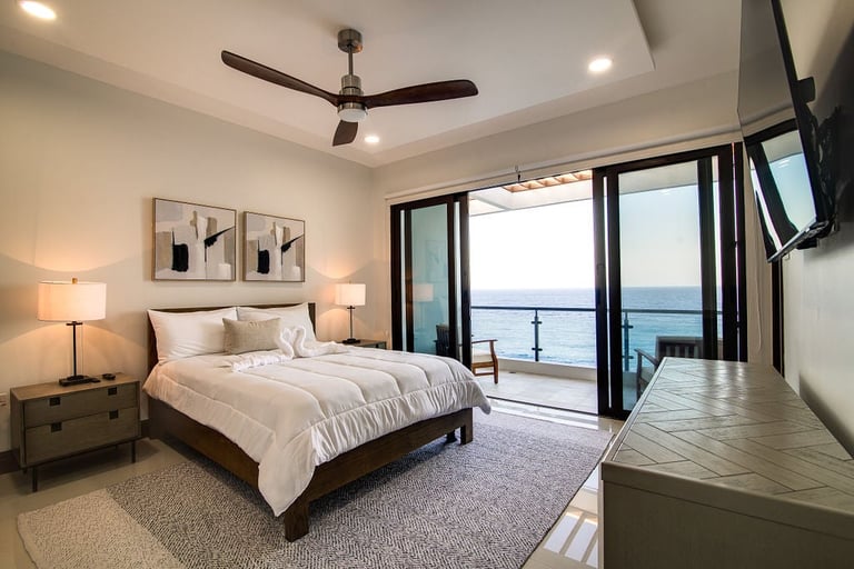 Bedroom with sliding glass doors opening to a sea view